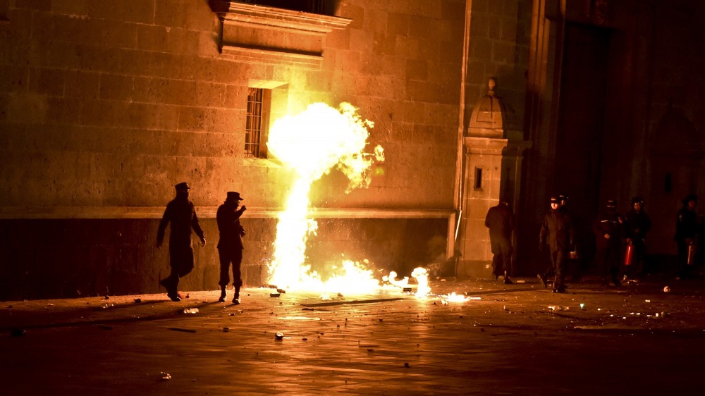 Image: Students face riot police outside Mexico's National Palace